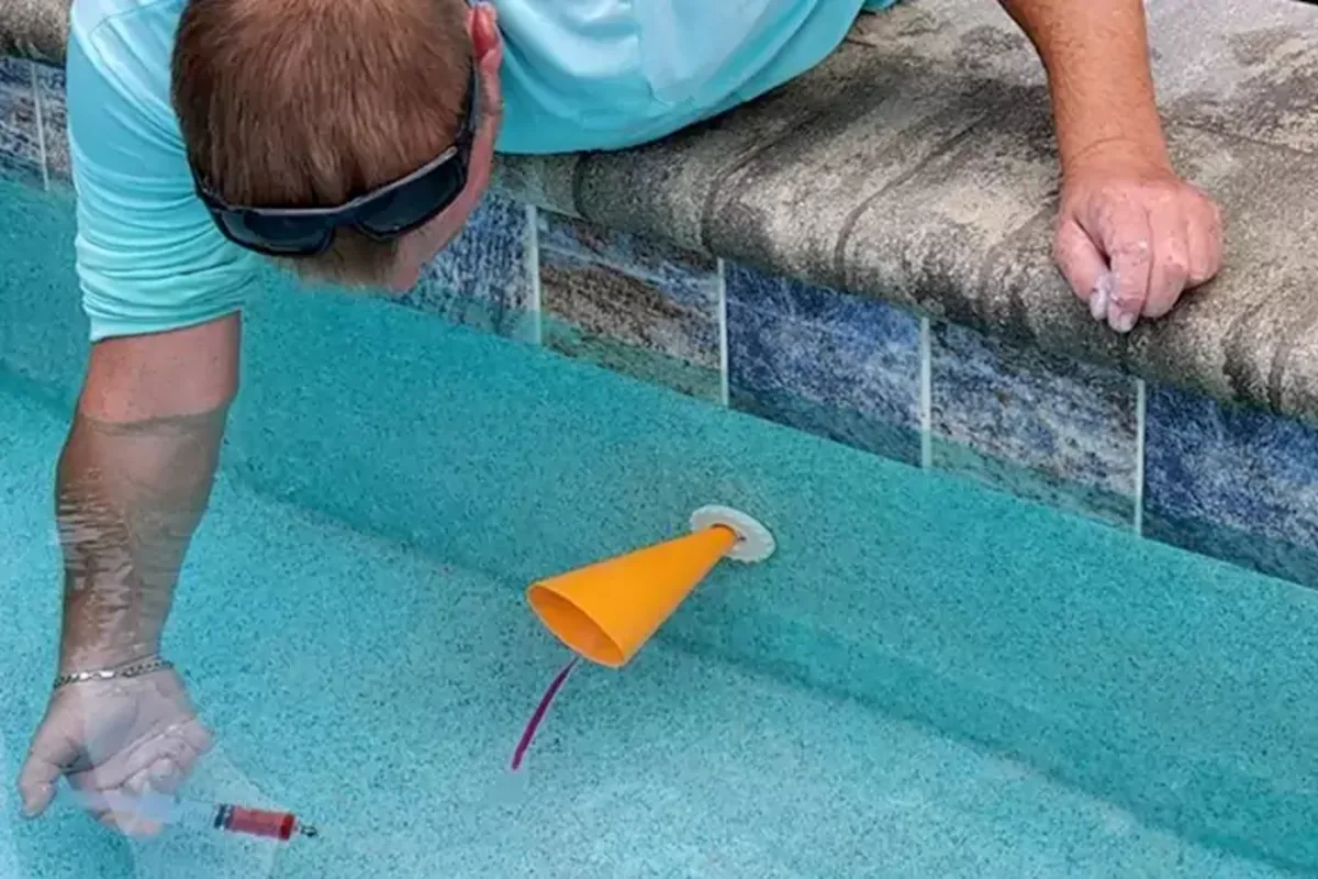 Before swimming pool leak detection project showing wet ground near buried pool plumbing