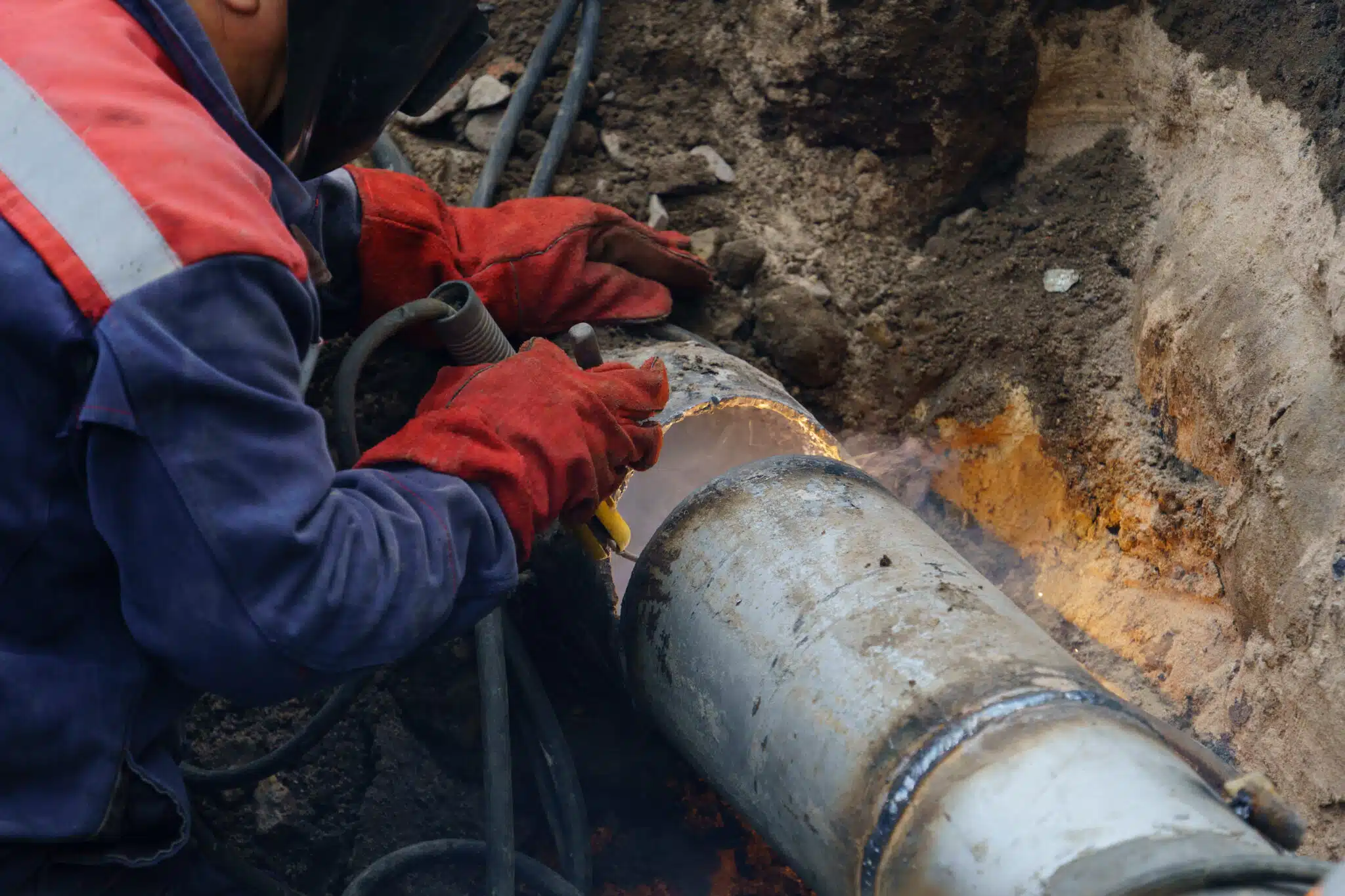 Utility crew working on an exposed underground water line
