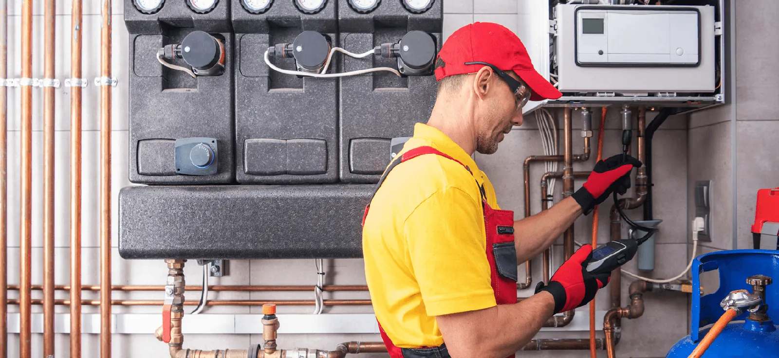 Technician testing pipes during gas leak detection